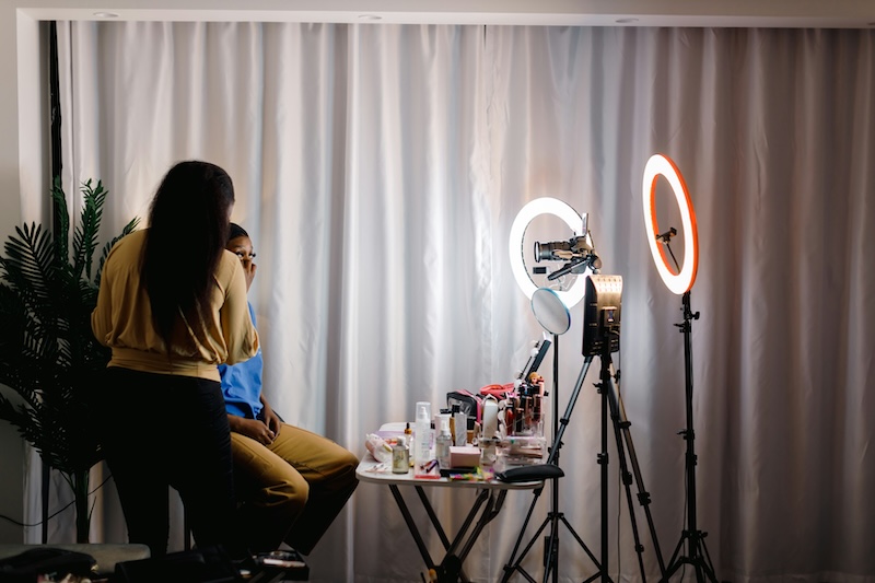 Staged UGC shoot: a makeup session in front of two ring lights
